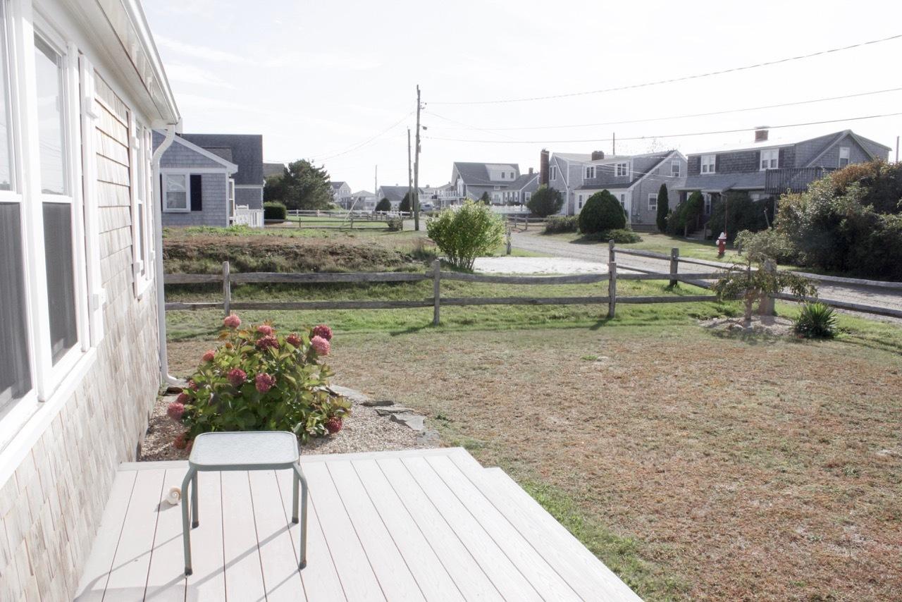 4 Beach Road West Dennis, MA 02670 - Photo 4 of 22 a view of a garden with a bench