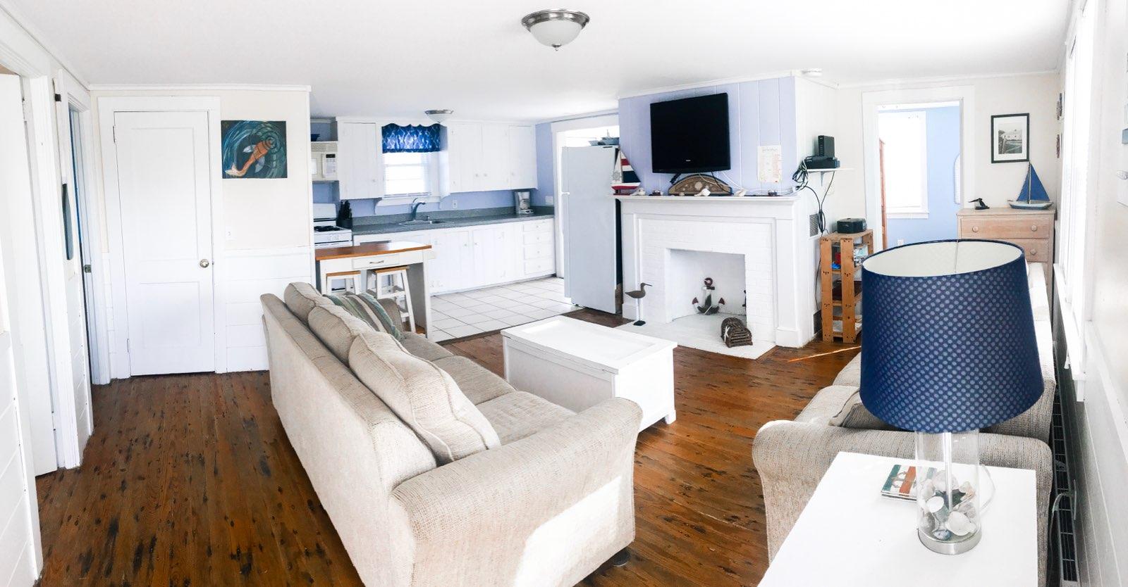 4 Beach Road West Dennis, MA 02670 - Photo 5 of 22 a living room with furniture a flat screen tv and a fireplace