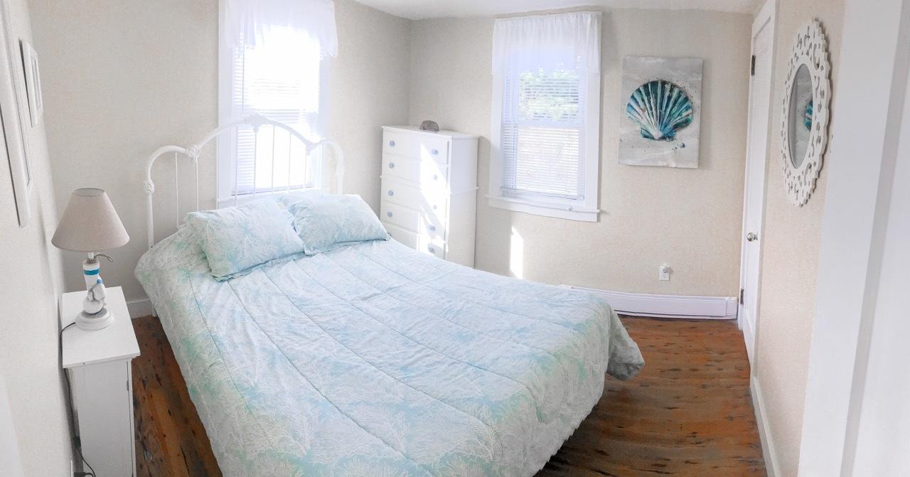 4 Beach Road West Dennis, MA 02670 - Photo 9 of 22 a bedroom with bed and wooden floor
