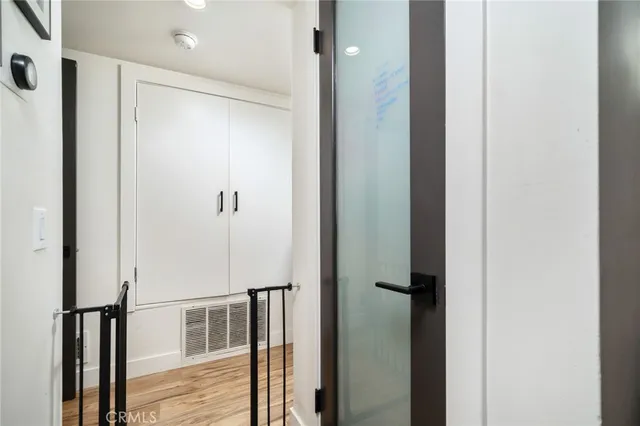 a bedroom with a bed and a night stand