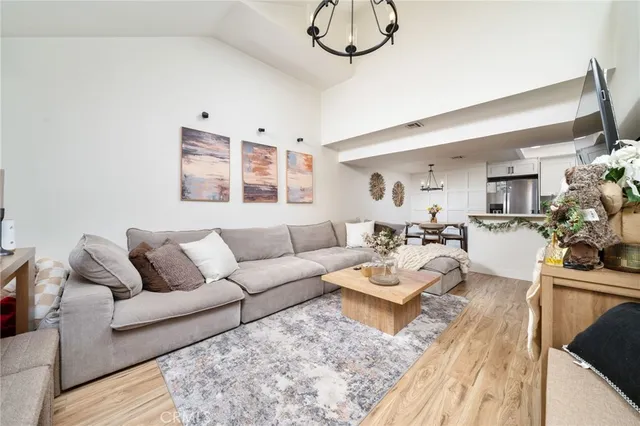 a kitchen with stainless steel appliances granite countertop a refrigerator a stove top oven a sink a counter space and cabinets