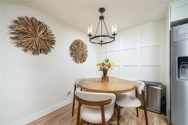 a kitchen with a refrigerator a sink and white cabinets