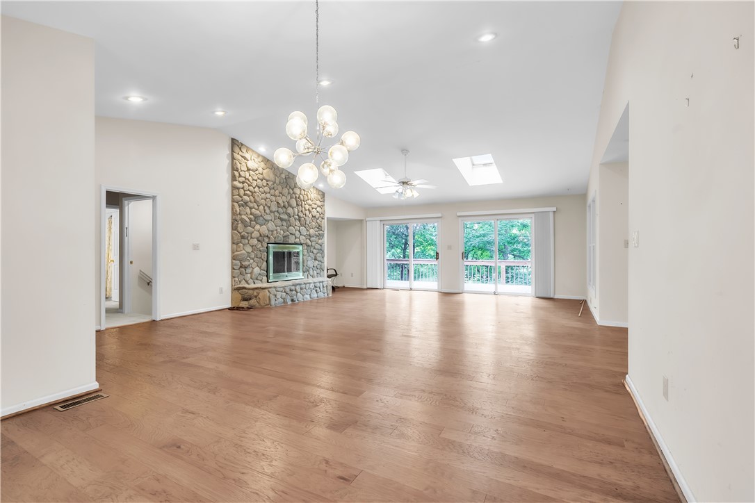 149 Inlet Pointe Drive Anderson, SC 29625 - Photo 6 of 43 A spacious living area with hardwood floors and a striking stone fireplace.