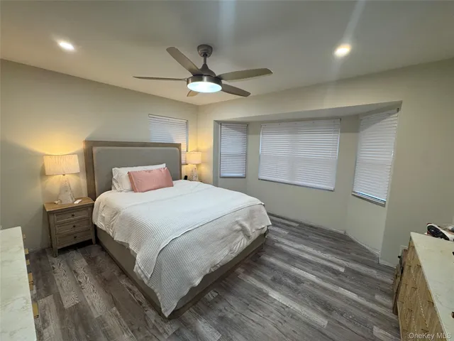 a bedroom with a large bed and a chandelier