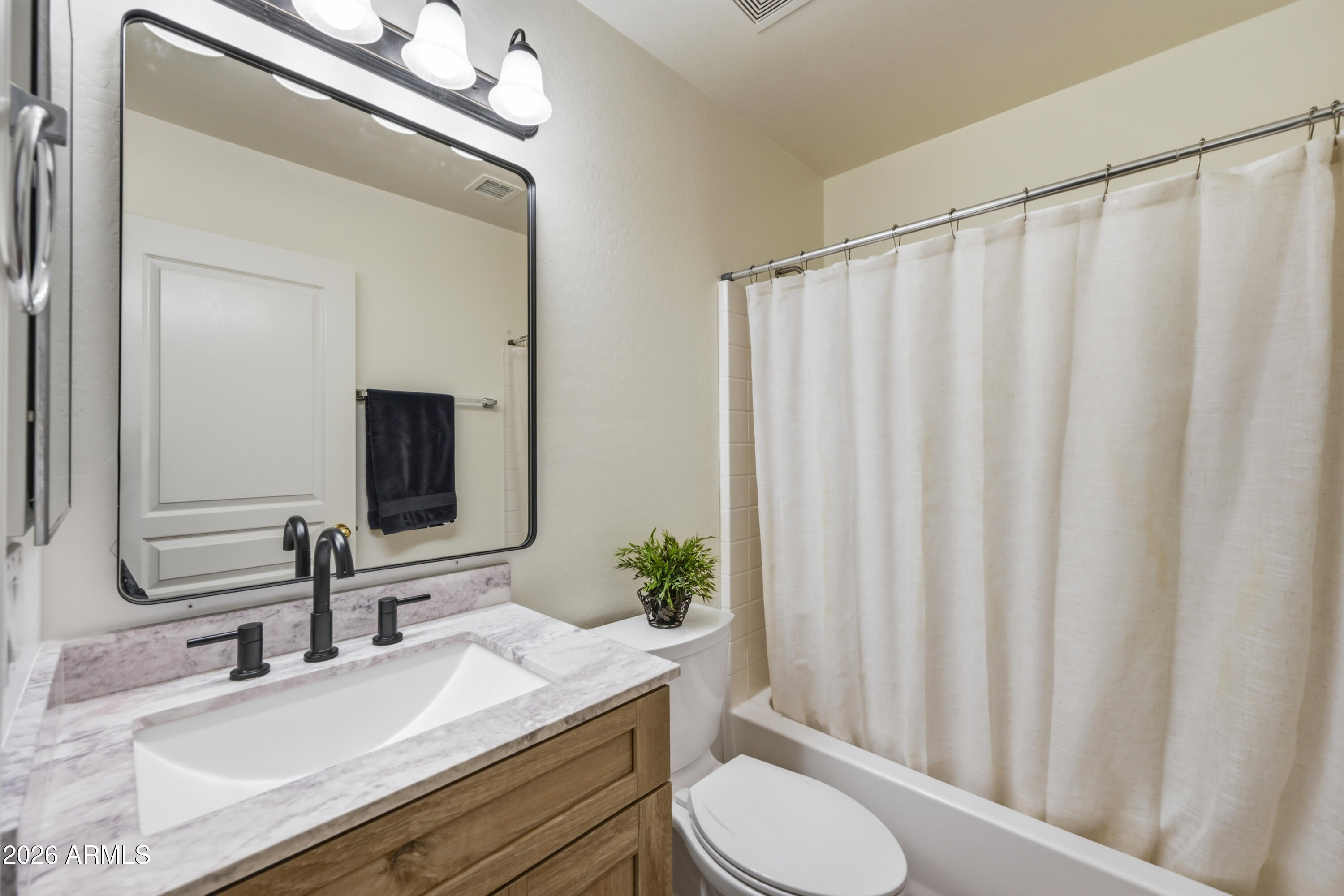 4372 West Alta Vista Road Laveen, AZ 85339 - Photo 21 of 47 a bathroom with a granite countertop sink and a mirror