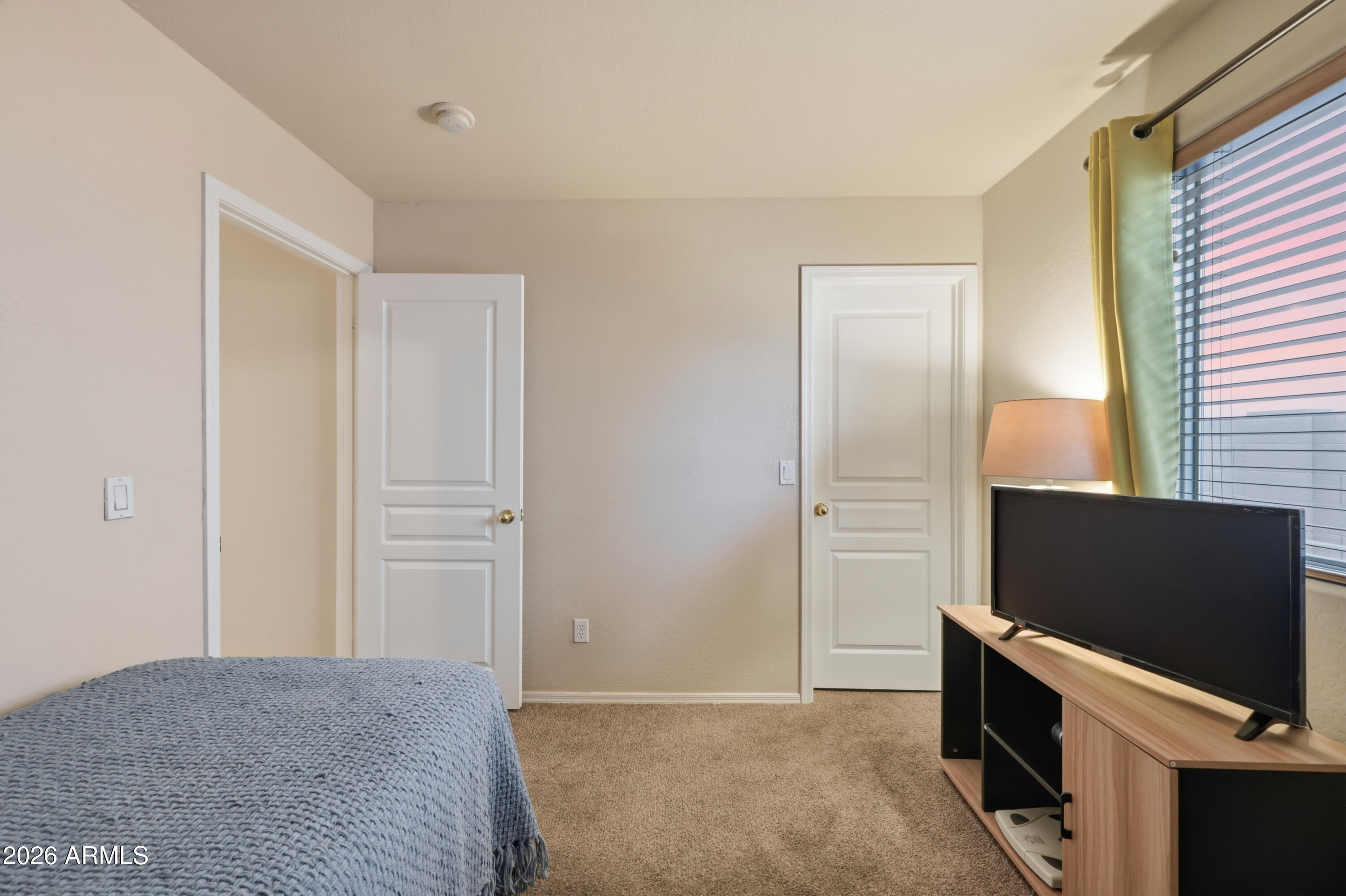 4372 West Alta Vista Road Laveen, AZ 85339 - Photo 24 of 47 a living room with a flat screen tv on dresser and a window