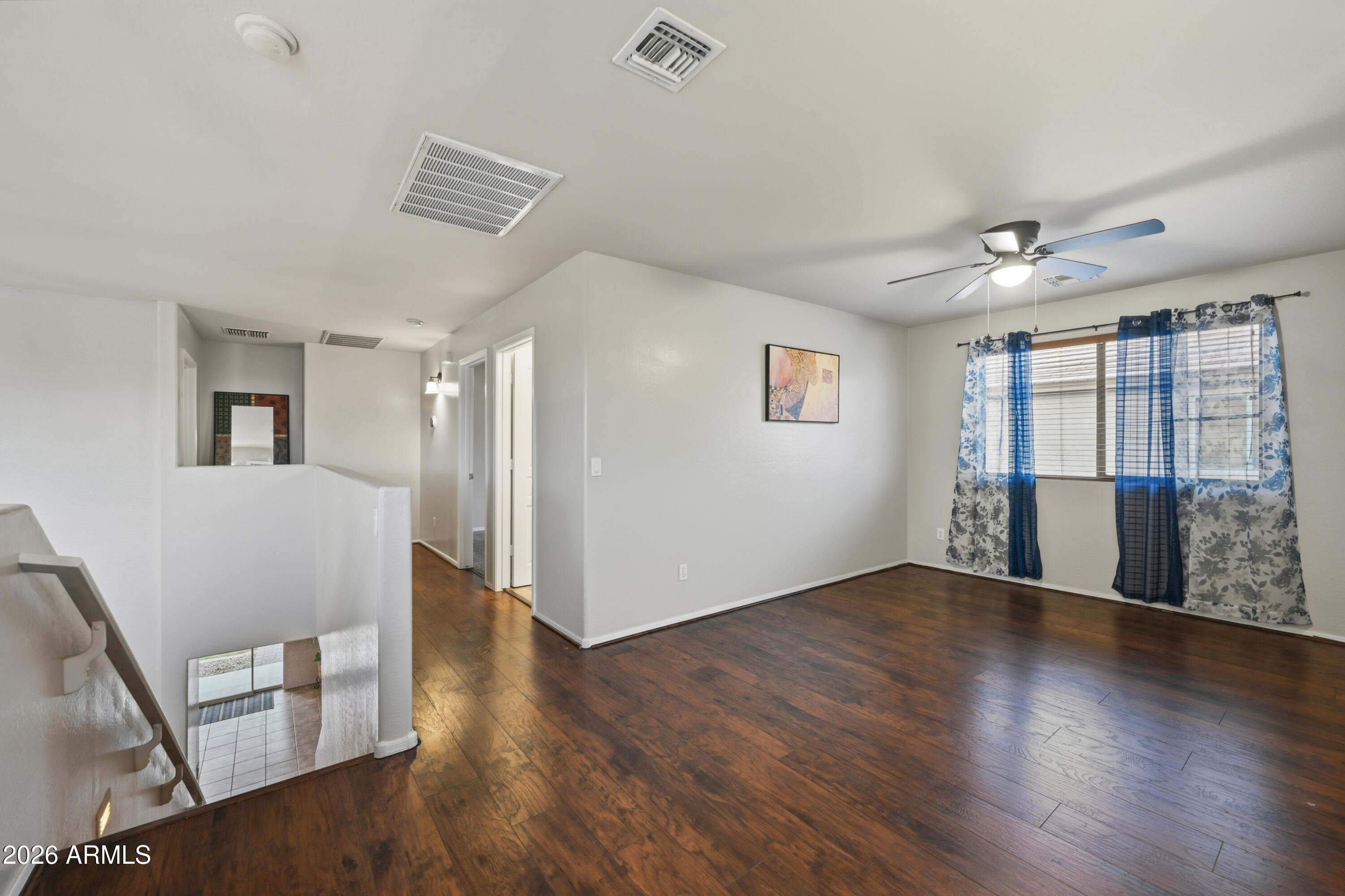 4372 West Alta Vista Road Laveen, AZ 85339 - Photo 26 of 47 a view of an empty room with wooden floor and a window