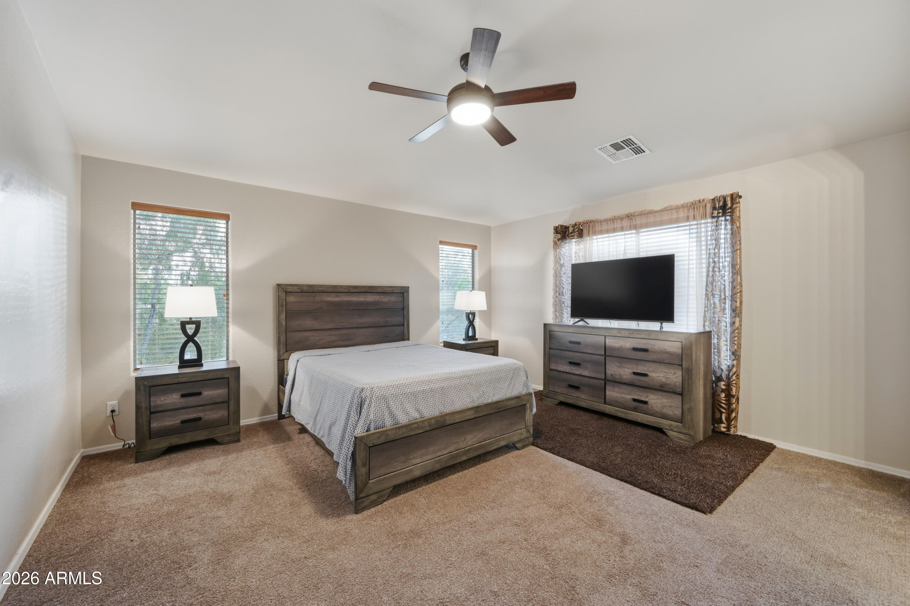 4372 West Alta Vista Road Laveen, AZ 85339 - Photo 31 of 47 a bedroom with a bed and a flat screen tv