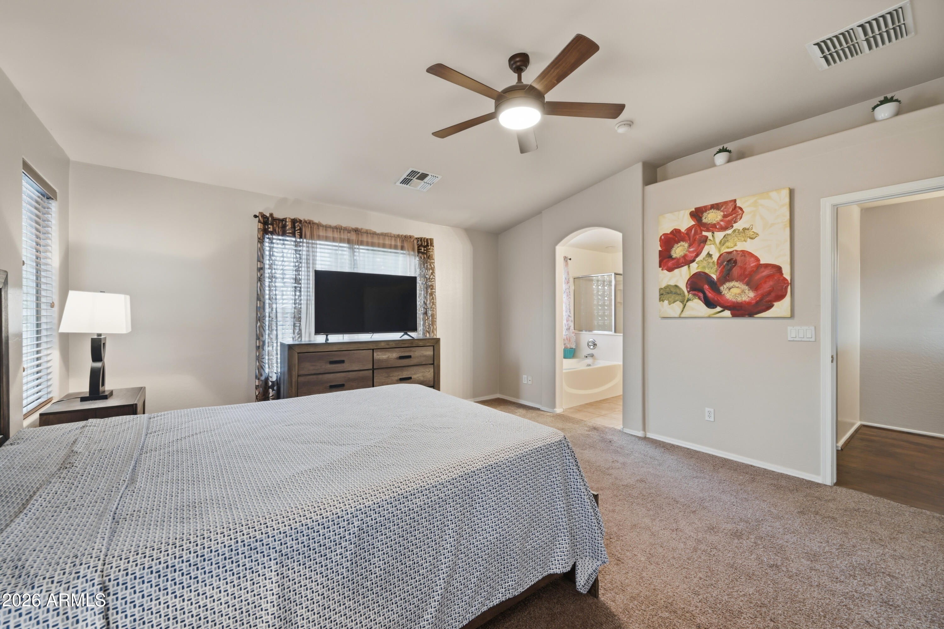 4372 West Alta Vista Road Laveen, AZ 85339 - Photo 33 of 47 a bedroom with a large bed and a flat screen tv