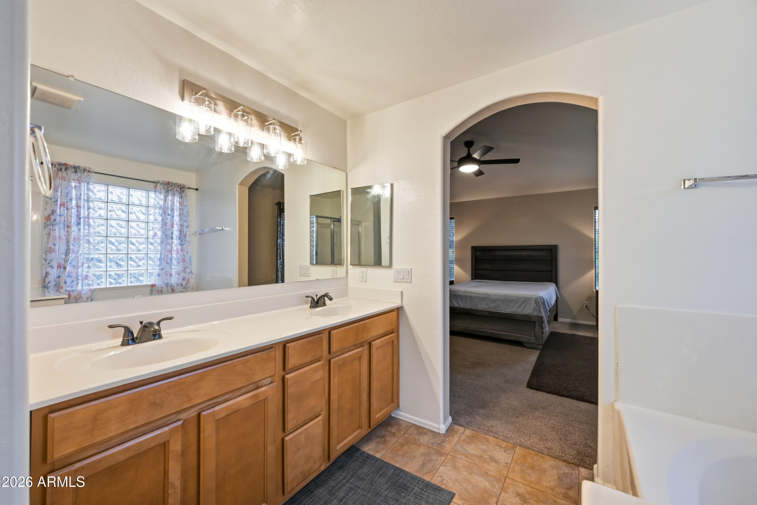 4372 West Alta Vista Road Laveen, AZ 85339 - Photo 36 of 47 a spacious bathroom with a double vanity sink and mirror