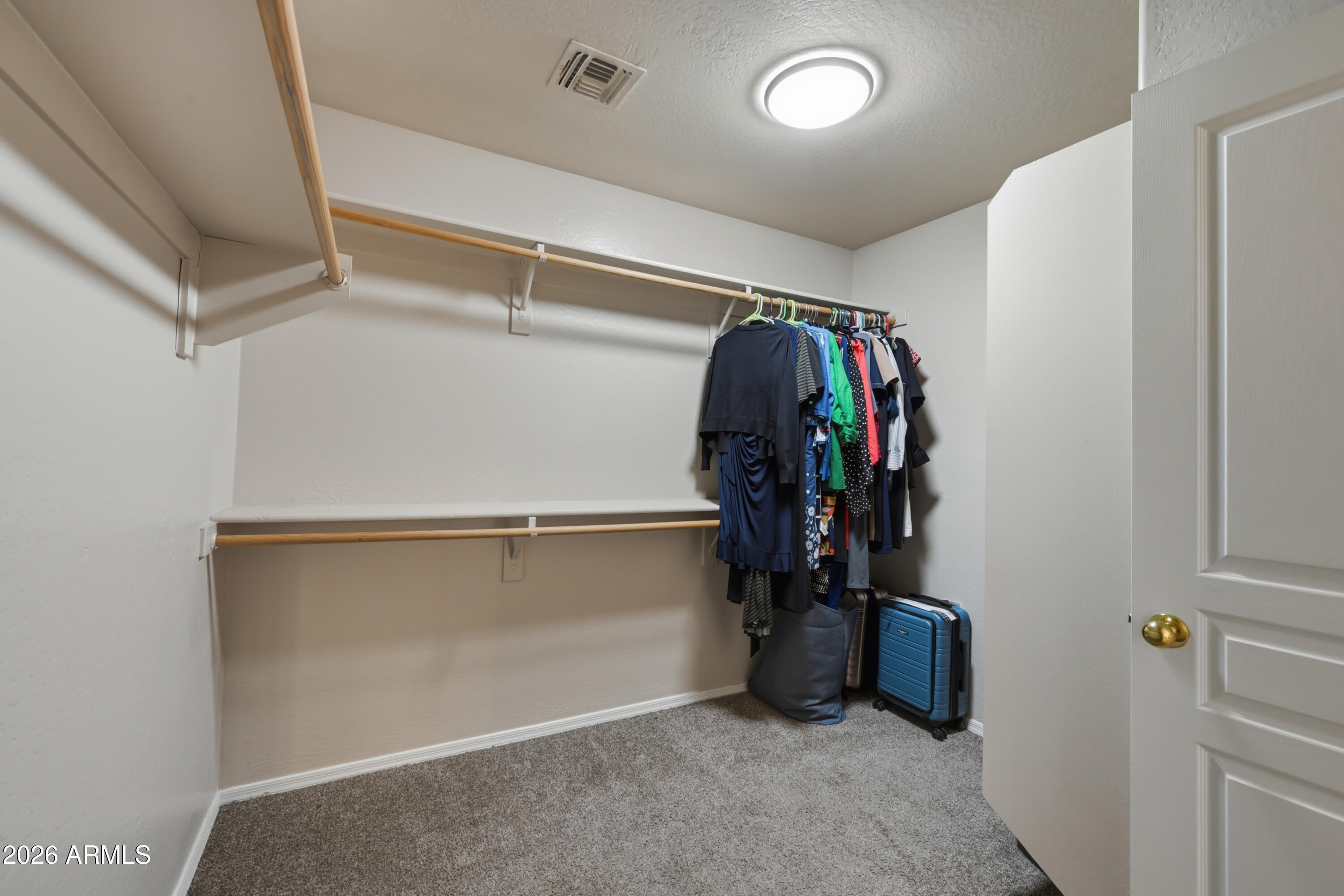 4372 West Alta Vista Road Laveen, AZ 85339 - Photo 37 of 47 a view of walk in closet with clothes and shoes