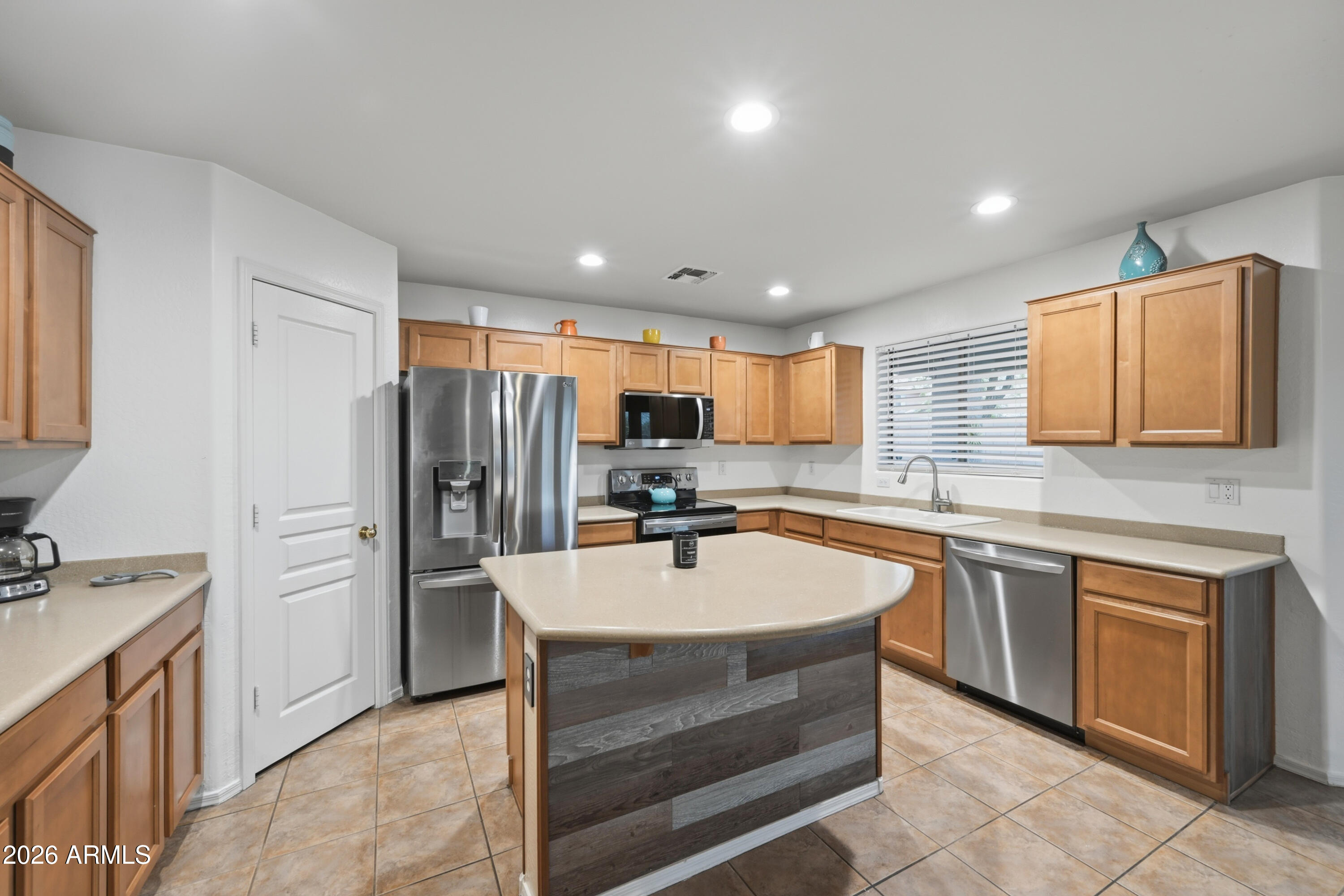 4372 West Alta Vista Road Laveen, AZ 85339 - Photo 39 of 47 a kitchen with a refrigerator sink and stove