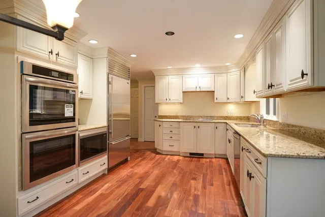 a kitchen with a sink stove top oven and cabinets