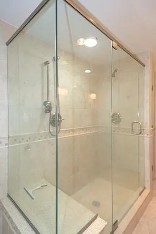 a bathroom that has a glass shower door