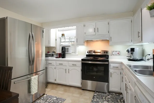 a kitchen with cabinets and stainless steel appliances