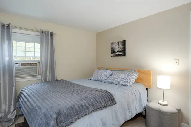 a bedroom with a bed and a lamp