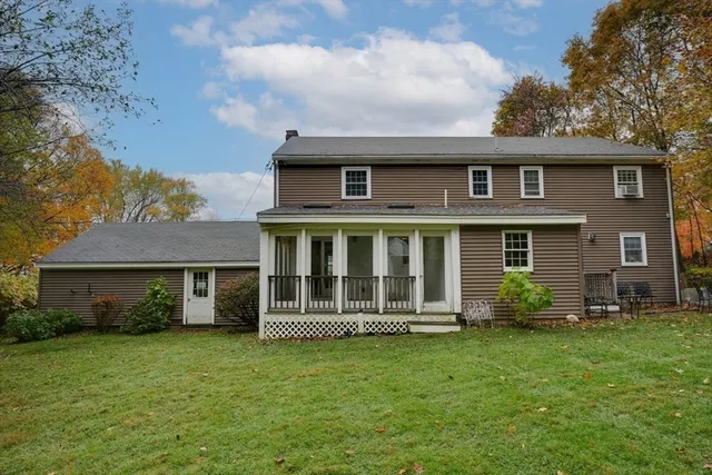 a front view of a house with a garden and plants