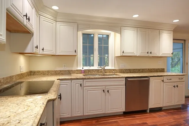 a kitchen with granite countertop a sink and cabinets
