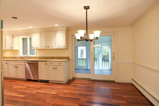 a view of a kitchen with a sink dishwasher and wooden floor
