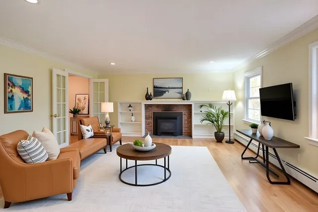 a living room with furniture flat screen tv and a fireplace