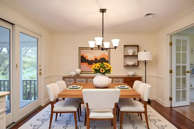 a dining room with furniture a chandelier and wooden floor
