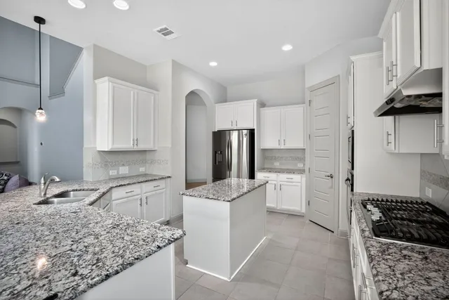 a kitchen with a sink stove and refrigerator