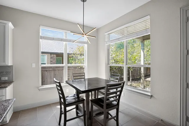a view of a dining room with furniture window and outside view