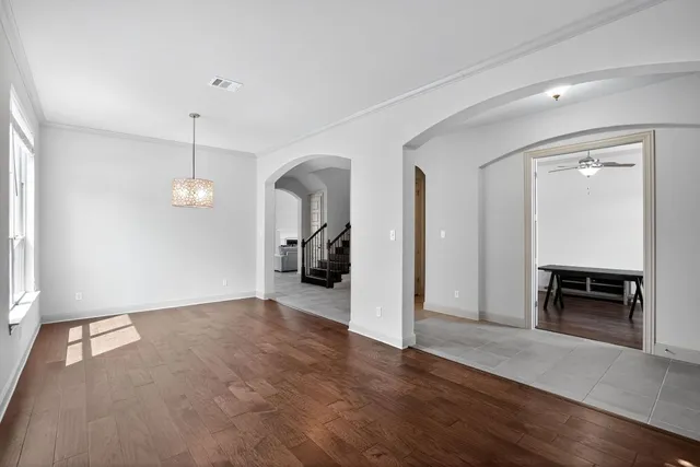 a view of empty room with wooden floor and fireplace