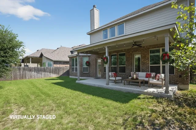 a view of a house with backyard porch and sitting area