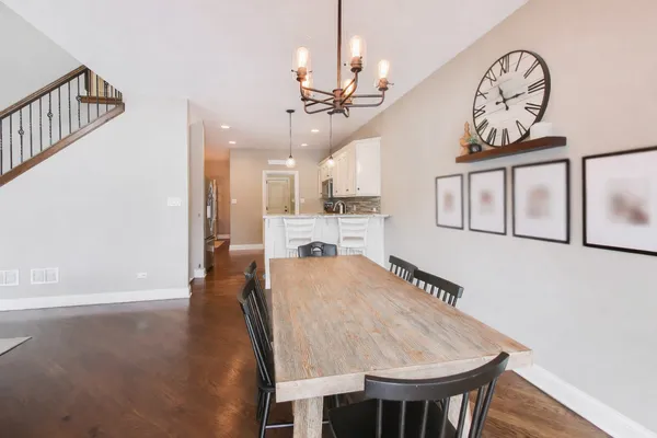 a view of a dining room with furniture and a chandelier