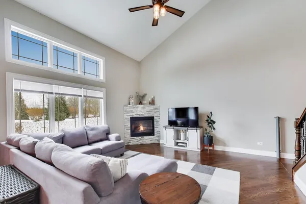a living room with furniture a fireplace and a flat screen tv