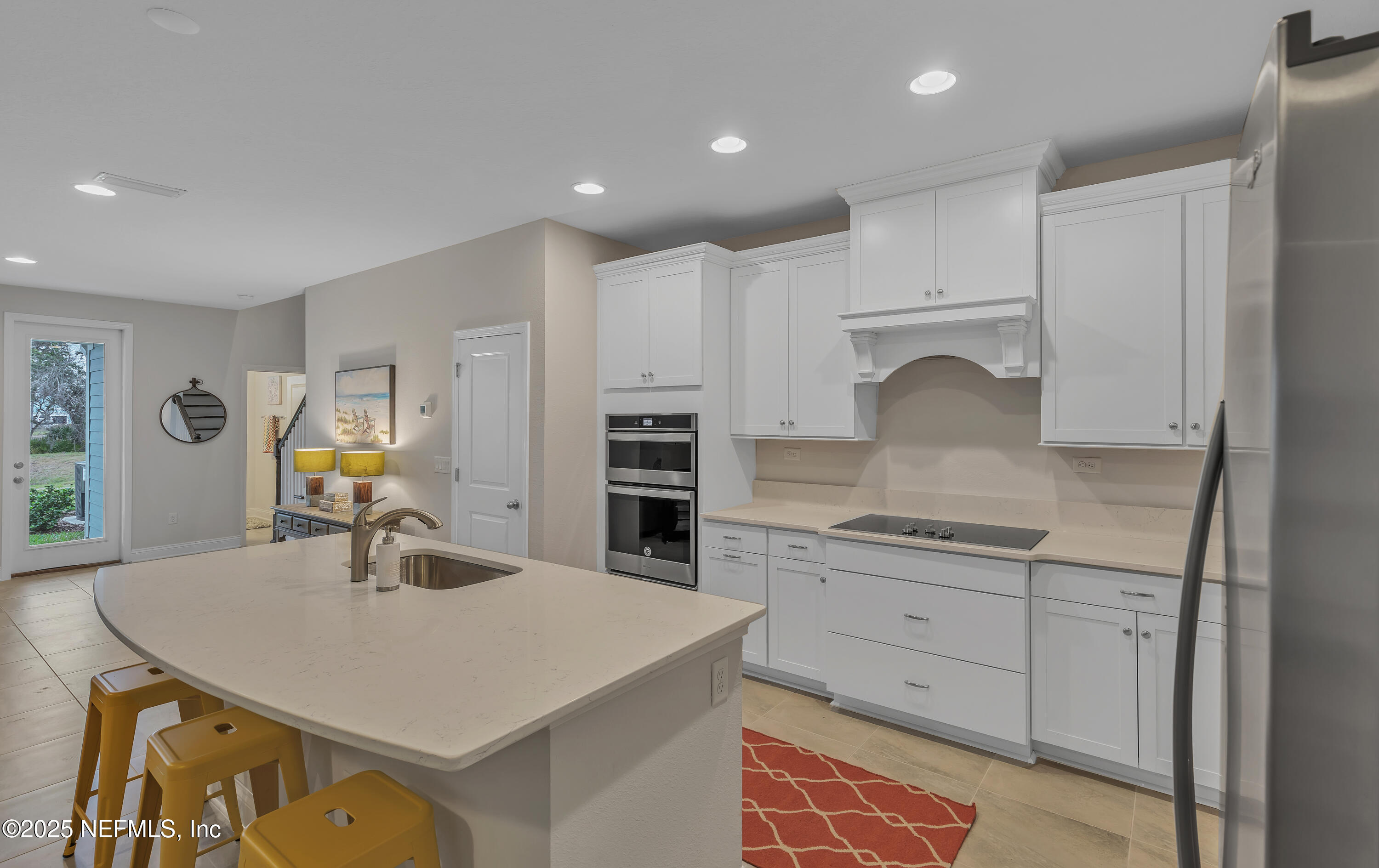 381 Woods Lane St. Augustine, FL 32092 - Photo 12 of 16 a kitchen with kitchen island a sink stove and refrigerator