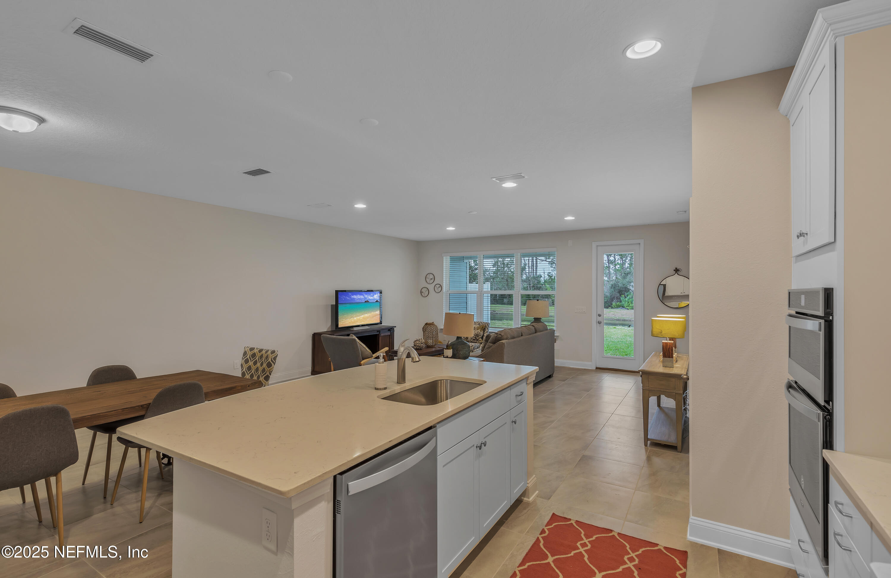 381 Woods Lane St. Augustine, FL 32092 - Photo 13 of 16 a kitchen with a sink and a refrigerator