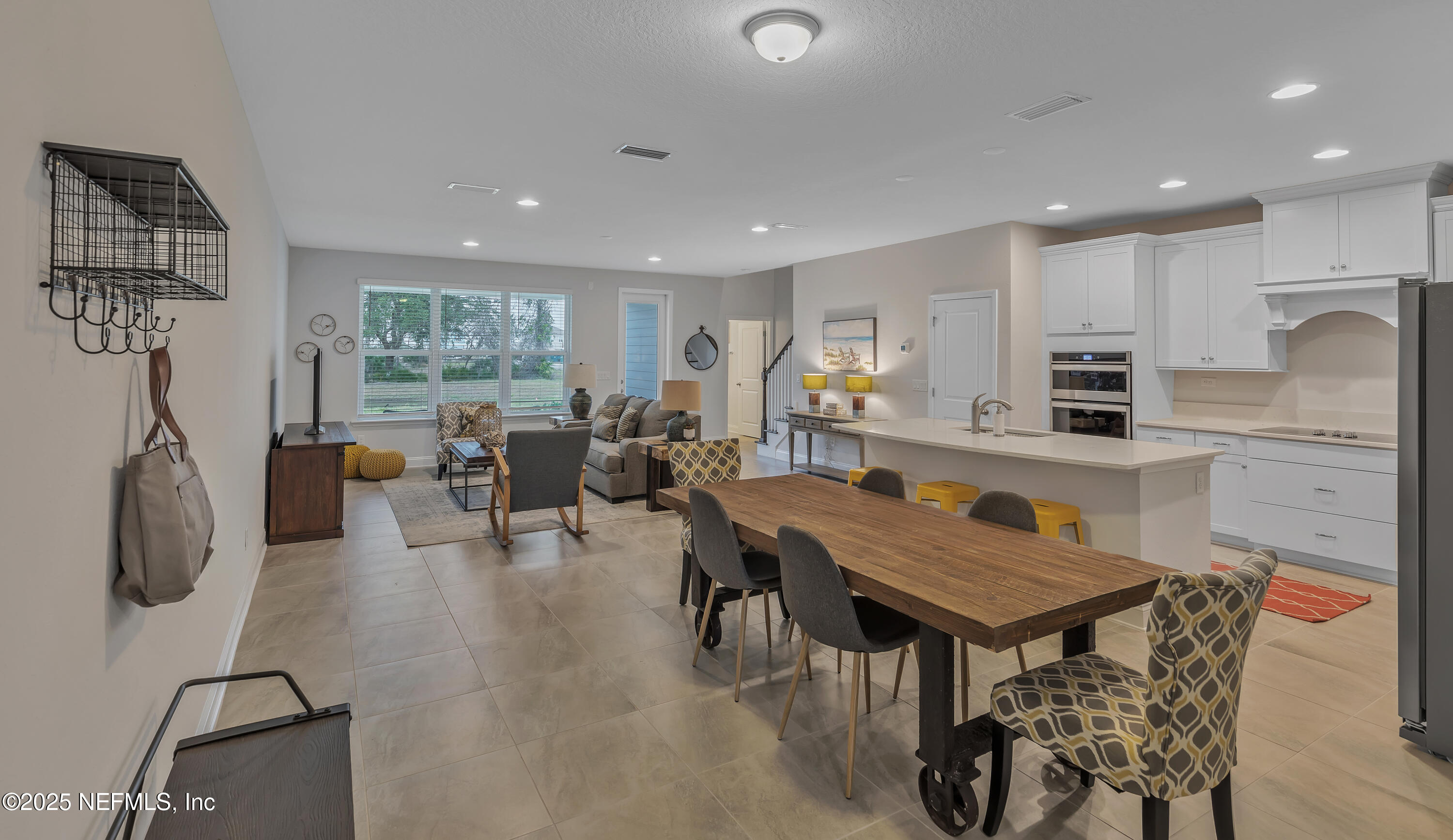 381 Woods Lane St. Augustine, FL 32092 - Photo 3 of 16 a living room with furniture a dining table and kitchen view