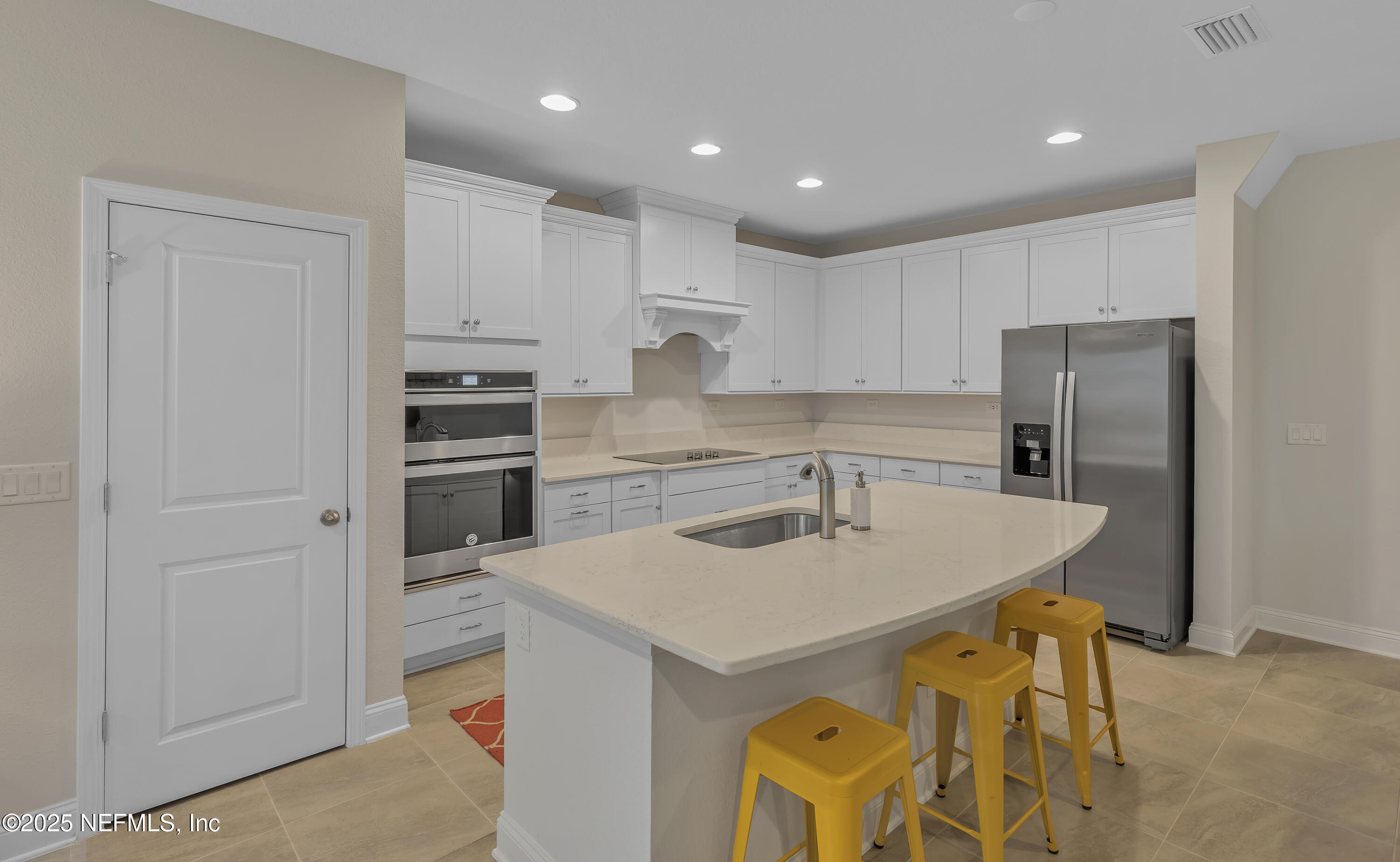 381 Woods Lane St. Augustine, FL 32092 - Photo 7 of 16 a kitchen with a sink a stove a refrigerator and white cabinets