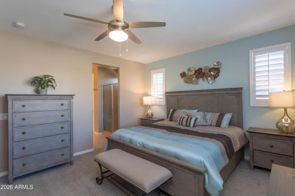 a bedroom with a bed and a dresser in it