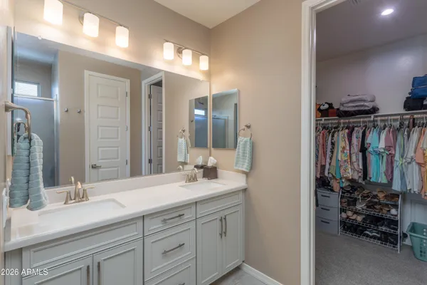 a en suite bathroom with double sink and a mirror