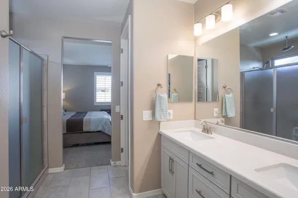 a en suite bathroom with a double vanity sink and mirror