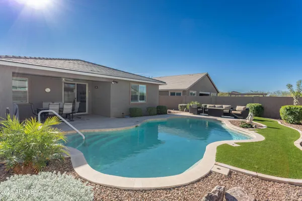 a view of a swimming pool with a yard