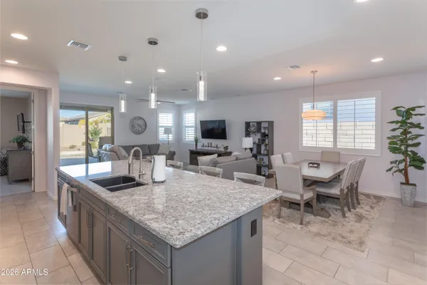 a kitchen with granite countertop kitchen island stainless steel appliances a sink and couch