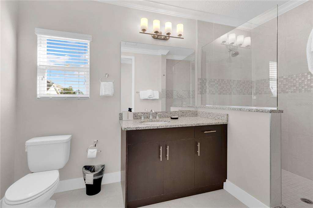 7580 Excitement Drive Reunion, FL 34747 - Photo 14 of 47 a bathroom with a toilet sink and mirror