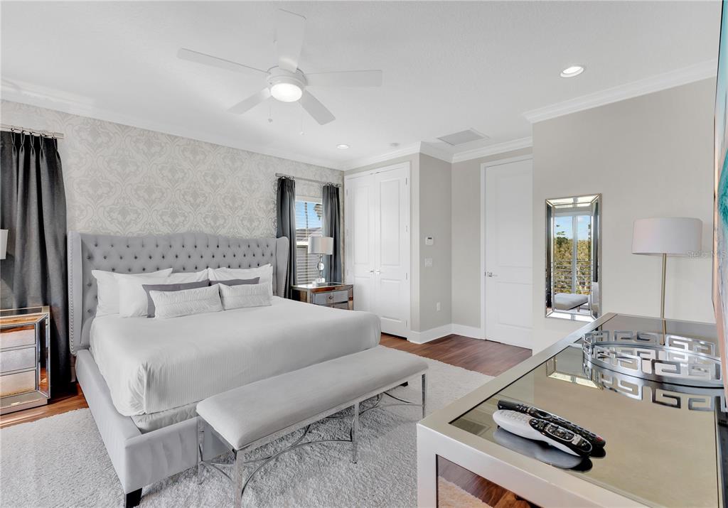 7580 Excitement Drive Reunion, FL 34747 - Photo 16 of 47 a bedroom with a bed and a table with the mirror