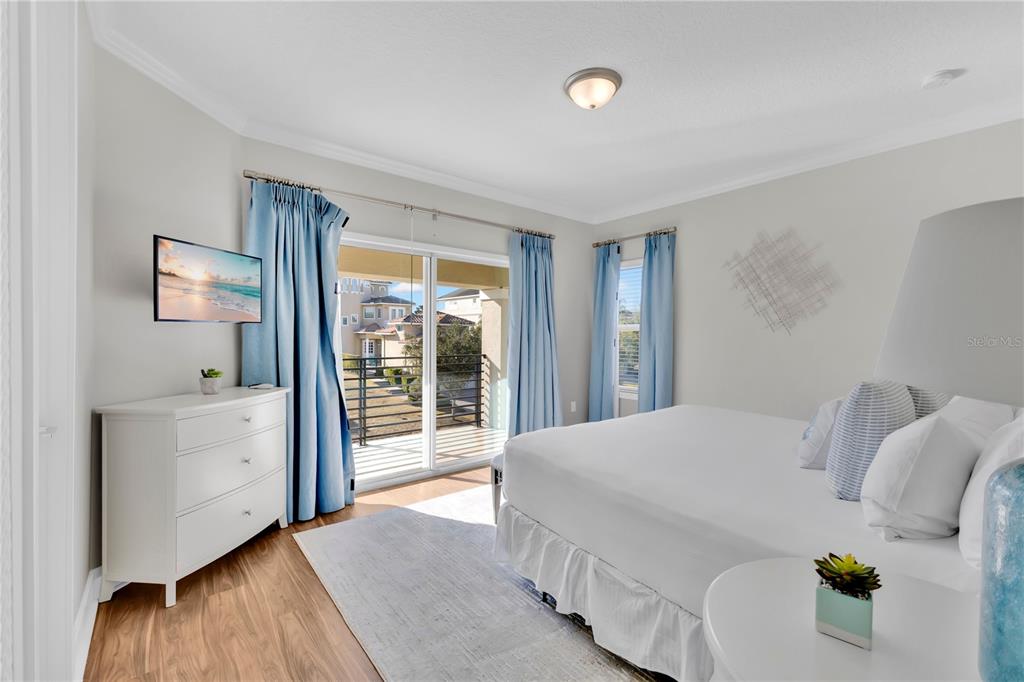 7580 Excitement Drive Reunion, FL 34747 - Photo 24 of 47 a spacious bedroom with a bed and wooden floor