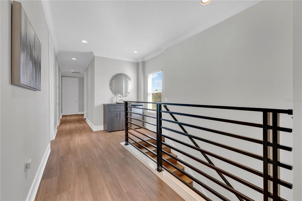 7580 Excitement Drive Reunion, FL 34747 - Photo 28 of 47 a view of a hallway with wooden floor and staircase