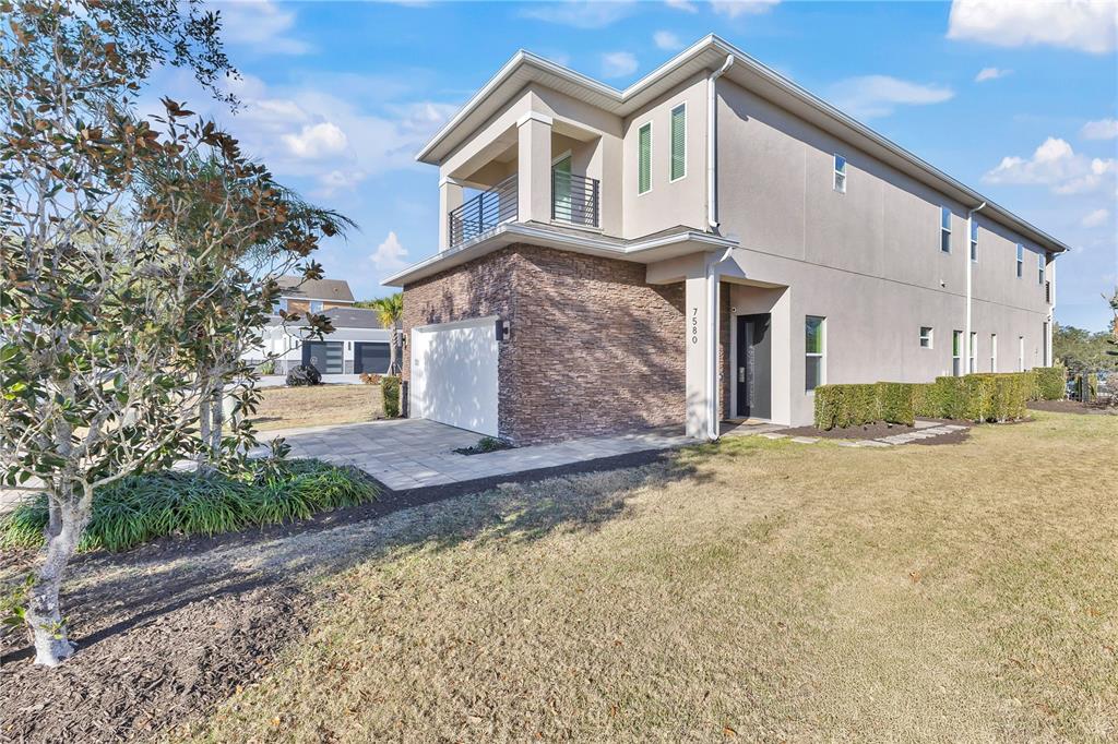7580 Excitement Drive Reunion, FL 34747 - Photo 3 of 47 a front view of a house with a yard and garage