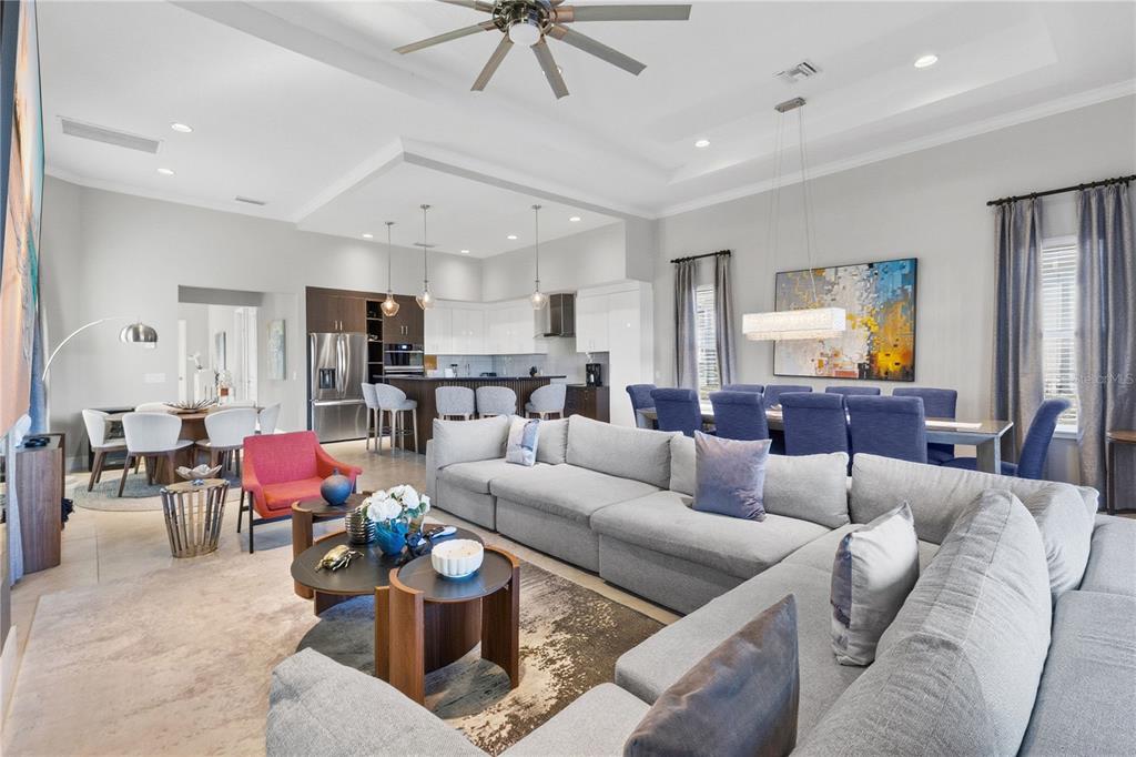 7580 Excitement Drive Reunion, FL 34747 - Photo 7 of 47 a living room with furniture kitchen view and a chandelier