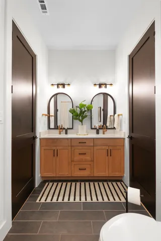 a bedroom with a bed a chandelier and a window