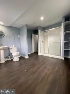 a bathroom with a sink toilet and a mirror