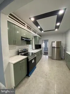 a kitchen with stainless steel appliances granite countertop a sink and a refrigerator