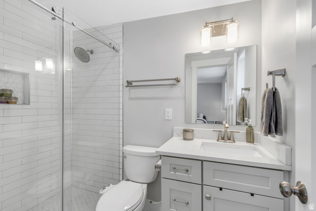 48 Moon Ridge Drive Murray, UT 84107 - Photo 14 of 30 Primary bathroom featuring a glass-enclosed shower with subway tile surround and a built-in niche